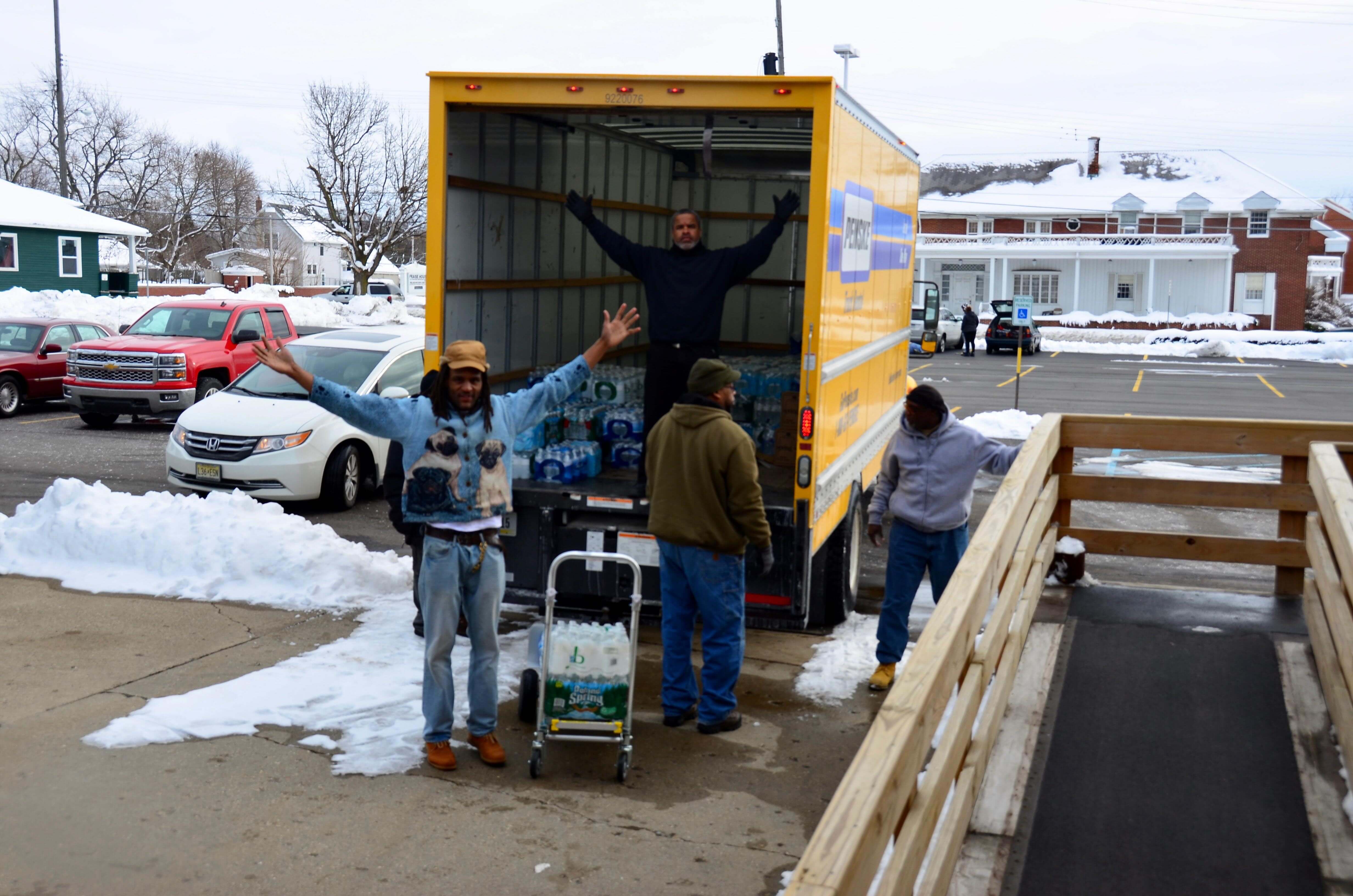Shawn Mills and others help to unload the truck at St. Andrew's Episcopal Church.