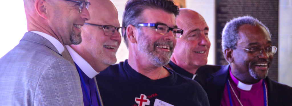 The Rev. Dan Scheid, the Rt. Rev. Todd Ousley, Craig Leavitt, the Very Rev. Jay Gantz, and the Most Rev. Michael Curry pose for a picture during the House of Bishops' visit to Flint, MI.